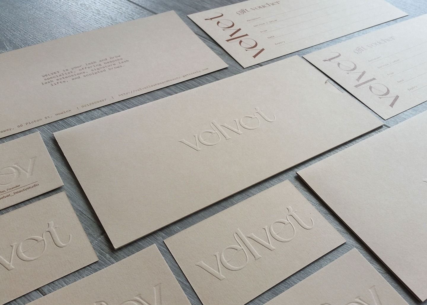 VELVET business cards with the wordmark pressed into the card