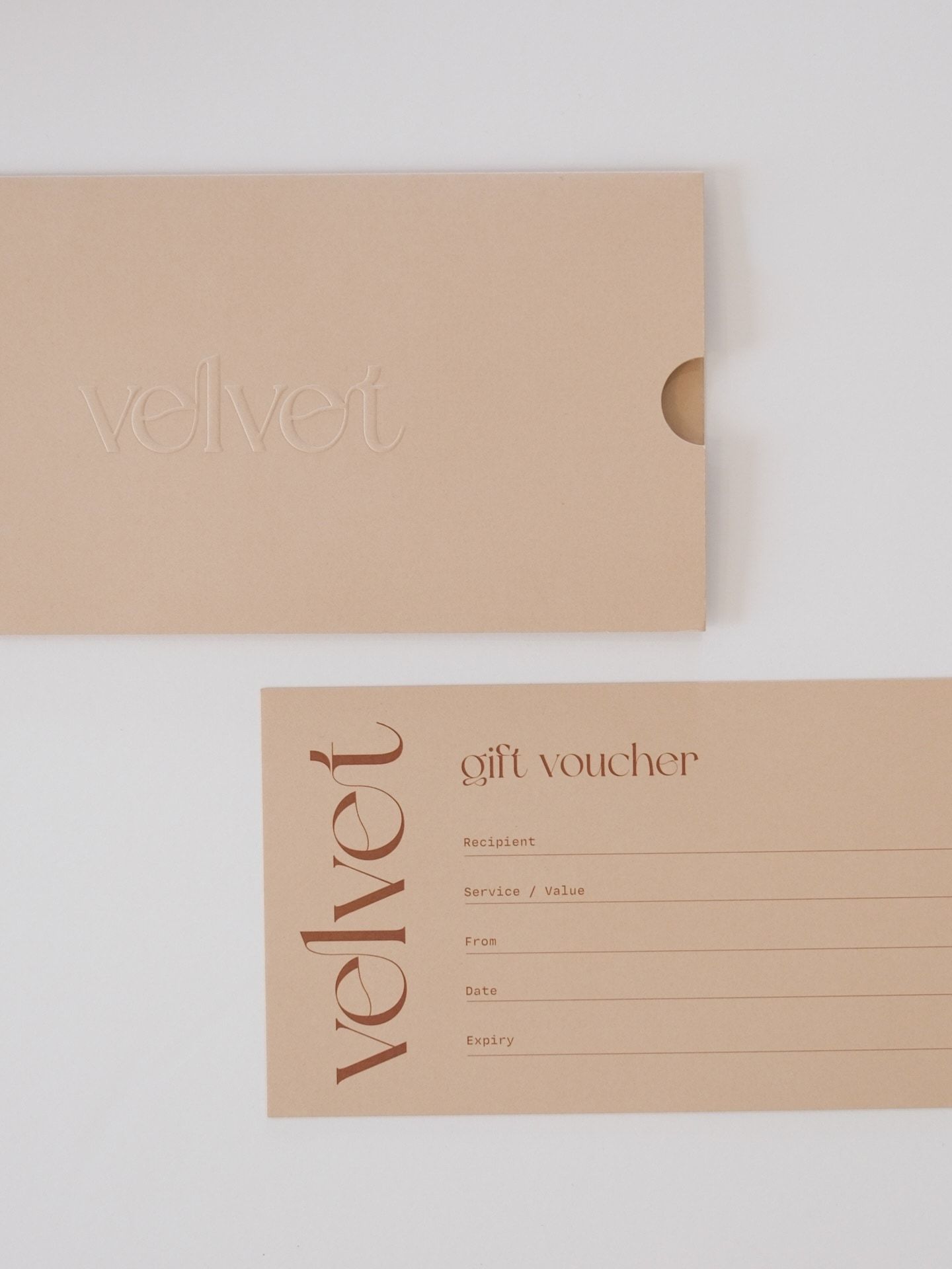 A VELVET gift voucher and its sleeve