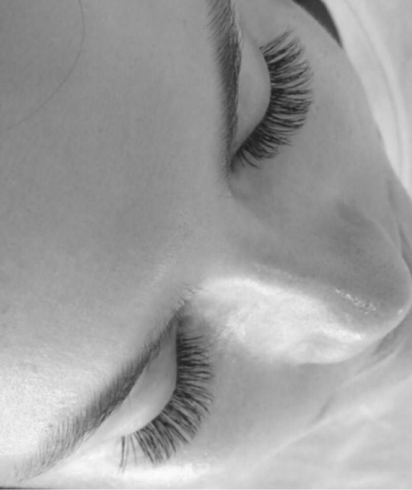Lash extensions with the eyes closed, in black and white