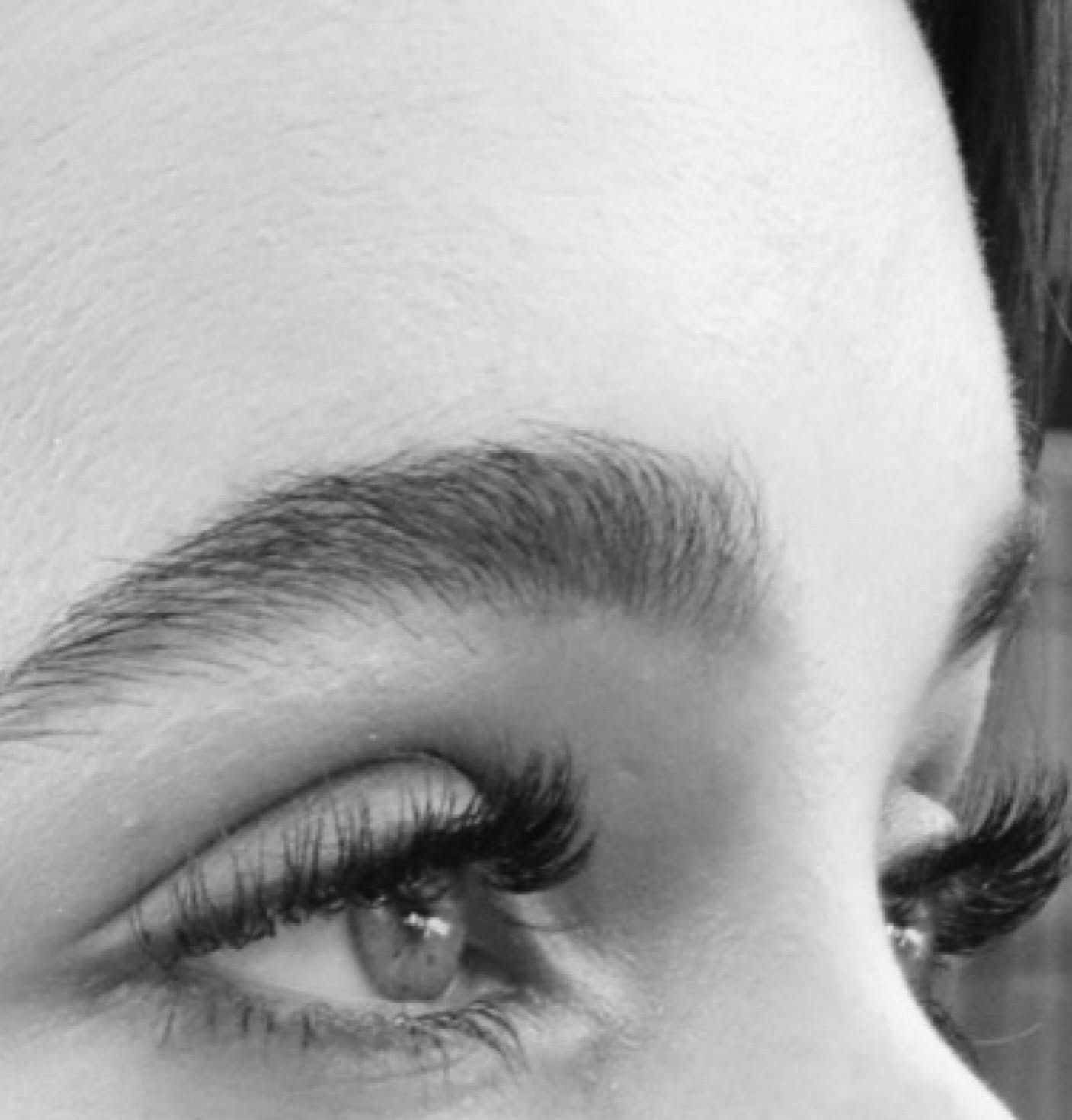 Black and white side view of lash extensions and a groomed brow